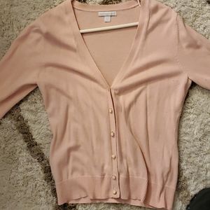 Pink button halfway up sweater